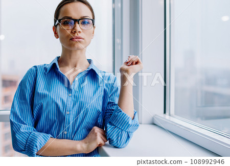 confident young businesswoman looking at camera dressed in formal wear 108992946