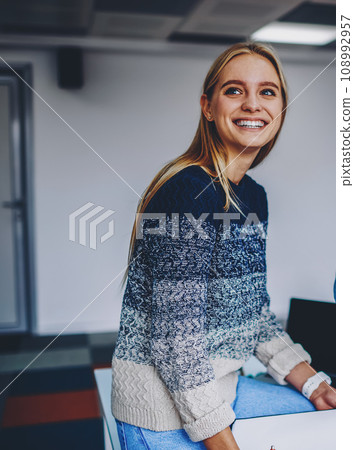 Positive young colleagues dressed in casual wear laughing during working process in office interior Positive young colleagues dressed in casual wear laughing during working process in office interior 108992957