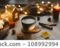 Autumn or winter cozy home interior with a cup, candles, plaid. Hygge home decor.  108992994