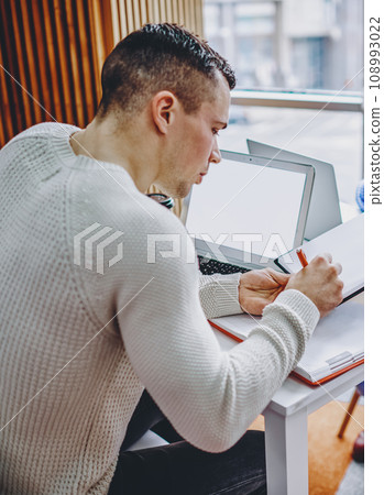 Young woman giving paper document for signing colleague during working process in office interior Young woman giving paper document for signing colleague during working process in office interior 108993022