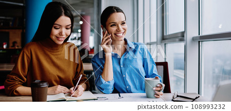 Happy caucasian women workers satisfied with planning project together at desktop 108993232