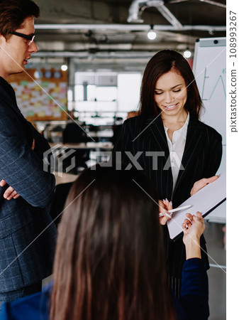 group of business partners in formal wear communicating 108993267