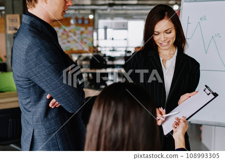 group of business partners in formal wear communicating group of business partners in formal wear communicating 108993305