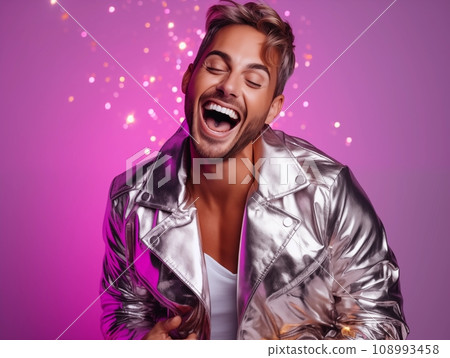 Young pretty man dressed in sequined jacket having fun on New Year party, happy guy dancing and laughing with sparkles and confetti, purple and cold colors Young pretty man dressed in sequined jacket having fun on New Year party, happy guy dancing and laughing with sparkles and confetti, purple and cold colors 108993458