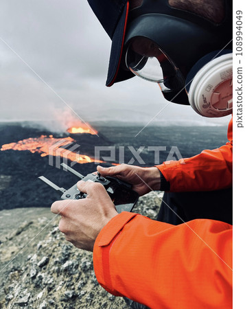 Drone Pilot Watching Volcanic Eruption in Iceland 2023. 108994049