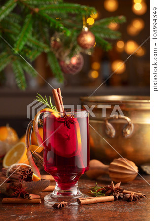 Christmas mulled wine with spices, citrus, and vintage kitchen utensils. 108994349