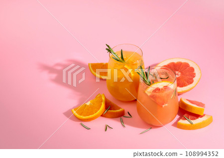 Summer cocktails with grapefruit, orange, rosemary, and ice. 108994352
