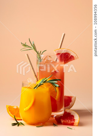 Orange and grapefruit juice with rosemary and ice. 108994356