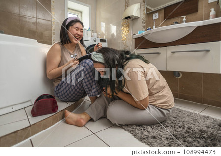 Asian laughing beauties begin their morning routine with acne treatment and facial massage in the bathroom 108994473