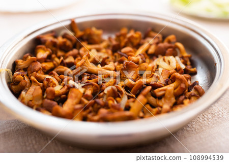 Traditional dishes of Eastern European cuisine. Fried chanterelles in pan Traditional dishes of Eastern European cuisine. Fried chanterelles in pan 108994539
