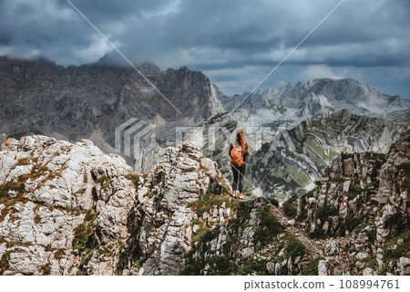 Woman Hiker Sitting on Rock in Mountain Landscape 108994761