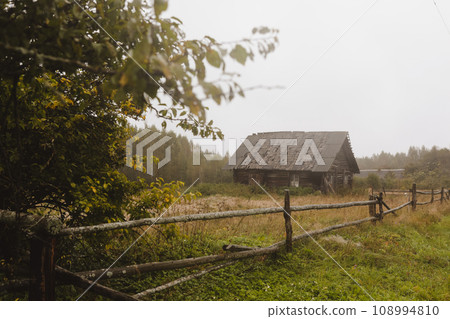 wooden house on a grassy hill in autumn. peaceful relax in the connection with nature. scenic image of picturesque rural nature in countryside in autumn wooden house on a grassy hill in autumn. peaceful relax in the connection with nature. scenic image of picturesque rural nature in countryside in autumn 108994810