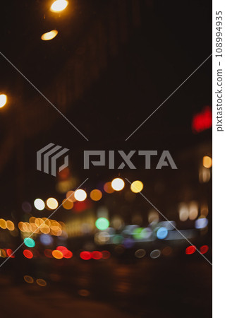Colorful lights of urban city surrounding moving and blurred by motion. the light trails on the street. Blurred defocused lights of city traffic  108994935