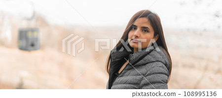 Banner beautiful indian woman generation z relaxing and feeling nature at autumn park in fall season copy space. Diversity and gen z youth 108995136