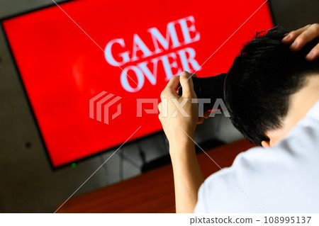 man playing video games at home 108995137