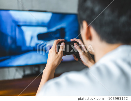 man playing video games at home 108995152