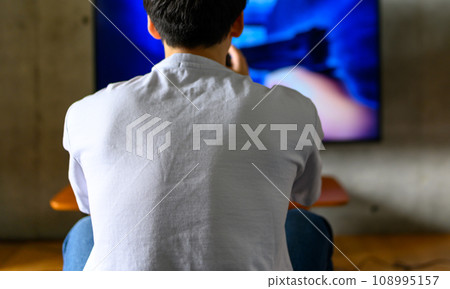 man playing video games at home man playing video games at home 108995157