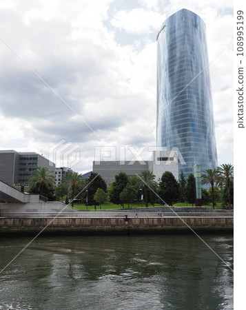 Nervion river with Iberdrola tower in European Bilbao city in Spain - vertical Nervion river with Iberdrola tower in European Bilbao city in Spain - vertical 108995199