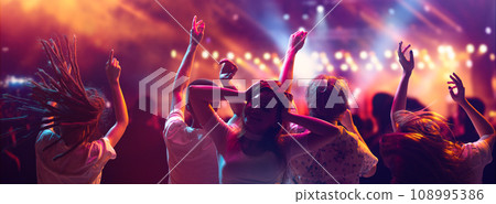 Banner. crowd of young attractive people, students on summer music festival dancing and singing in neon light and stage smoke. 108995386
