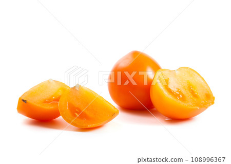 Cut and whole of yellow tomato isolated on white background. Cut and whole of yellow tomato isolated on white background. 108996367