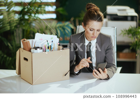 concerned woman employee in green office talking on phone 108996443