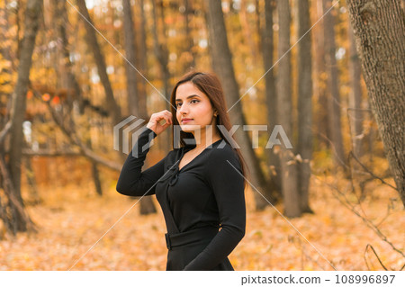 Close up portrait of pretty indian young woman enjoying warm autumn sunny day vacation outdoors copy space mockup. Generation z and gen z concept. Fall Season 108996897