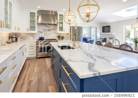 Interior of a modern bright kitchen with an island table and a hob, marble and wood finishes Interior of a modern bright kitchen with an island table and a hob, marble and wood finishes 108996921