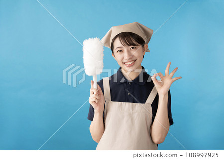 Female house cleaning worker with handy mop against blue background 108997925