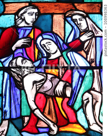 Pieta, stained glass window in Basilica of St. Vitus in Ellwangen, Germany 108998363