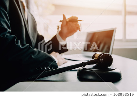 Business and lawyers discussing contract papers with brass scale on desk in office. Law, legal services, advice, justice and law concept picture with film grain effect 108998519