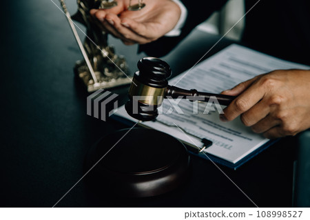 Business and lawyers discussing contract papers with brass scale on desk in office. Law, legal services, advice, justice and law concept picture with film grain effect 108998527
