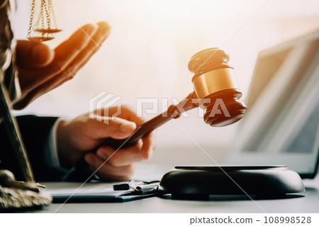 Business and lawyers discussing contract papers with brass scale on desk in office. Law, legal services, advice, justice and law concept picture with film grain effect 108998528