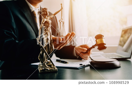 Business and lawyers discussing contract papers with brass scale on desk in office. Law, legal services, advice, justice and law concept picture with film grain effect 108998529