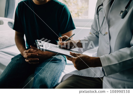 Doctor telling to patient woman the results of her medical tests. Doctor showing medical records to cancer patient in hospital ward. Senior doctor explaint the side effects of the intervention. 108998538