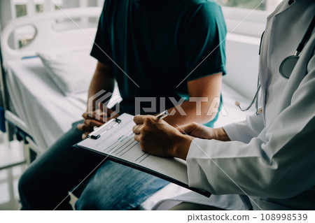 Doctor telling to patient woman the results of her medical tests. Doctor showing medical records to cancer patient in hospital ward. Senior doctor explaint the side effects of the intervention. 108998539