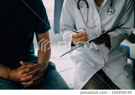 Doctor telling to patient woman the results of her medical tests. Doctor showing medical records to cancer patient in hospital ward. Senior doctor explaint the side effects of the intervention. 108998540