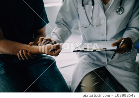 Doctor telling to patient woman the results of her medical tests. Doctor showing medical records to cancer patient in hospital ward. Senior doctor explaint the side effects of the intervention. 108998542
