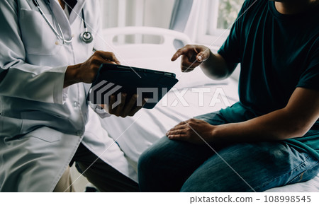 Doctor telling to patient woman the results of her medical tests. Doctor showing medical records to cancer patient in hospital ward. Senior doctor explaint the side effects of the intervention. 108998545