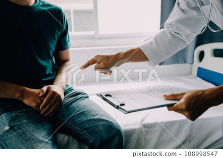 Doctor telling to patient woman the results of her medical tests. Doctor showing medical records to cancer patient in hospital ward. Senior doctor explaint the side effects of the intervention. 108998547