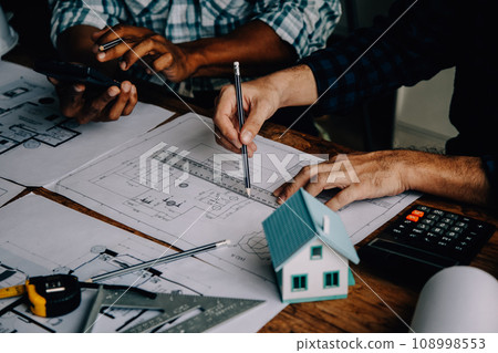 Construction and structure concept of Engineer or architect meeting for project working with partner and engineering tools on model building and blueprint in working site, contract for both companies. Construction and structure concept of Engineer or architect meeting for project working with partner and engineering tools on model building and blueprint in working site, contract for both companies. 108998553