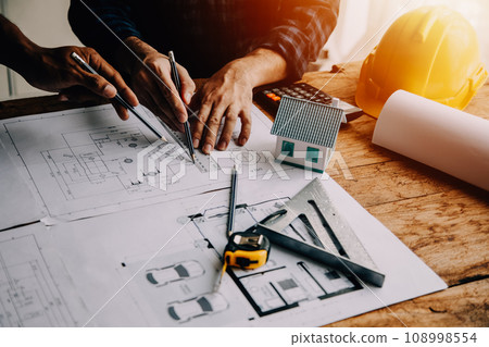 Construction and structure concept of Engineer or architect meeting for project working with partner and engineering tools on model building and blueprint in working site, contract for both companies. Construction and structure concept of Engineer or architect meeting for project working with partner and engineering tools on model building and blueprint in working site, contract for both companies. 108998554