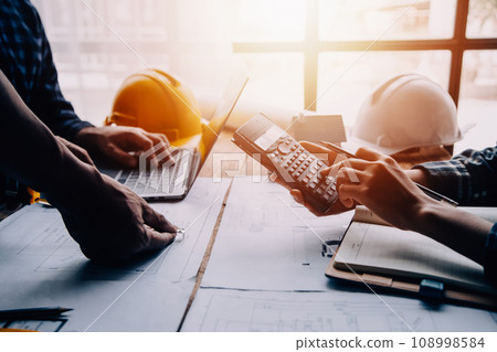 Construction and structure concept of Engineer or architect meeting for project working with partner and engineering tools on model building and blueprint in working site, contract for both companies. 108998584