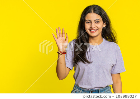 Happy woman smiling friendly waving hands gesturing hello greeting or goodbye, meeting invitation Happy woman smiling friendly waving hands gesturing hello greeting or goodbye, meeting invitation 108999027