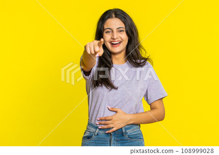 Happy excited Indian woman laughs out loud after hearing ridiculous anecdote, reaction on funny joke 108999028