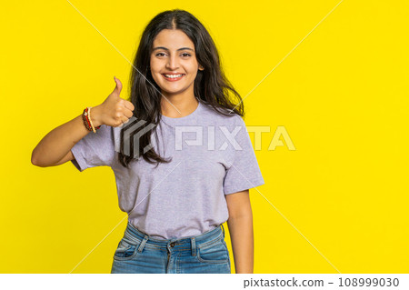 Indian woman raises thumbs up agrees or gives positive reply recommends advertisement like good idea Indian woman raises thumbs up agrees or gives positive reply recommends advertisement like good idea 108999030