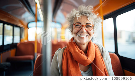 Stylish smiling senior woman with trendy glasses seated comfortably on a city bus, emanating positivity and contentment, graceful aged lady showcasing active and independent lifestyle in city Stylish smiling senior woman with trendy glasses seated comfortably on a city bus, emanating positivity and contentment, graceful aged lady showcasing active and independent lifestyle in city 108999106