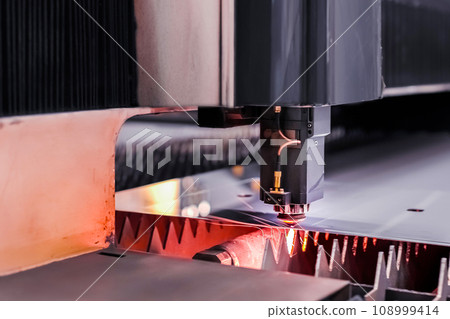 Scene close up, laser cutting machine cuts a metal plate. High-tech sheet metal production process using a laser cutting machine, CNC 108999414