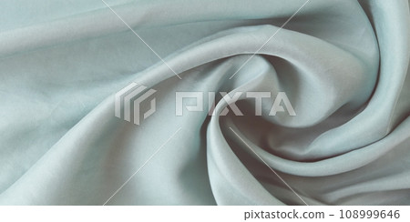 Light gray color natural silk draped in folds, top view, satin fabric texture, pastel shade Light gray color natural silk draped in folds, top view, satin fabric texture, pastel shade 108999646
