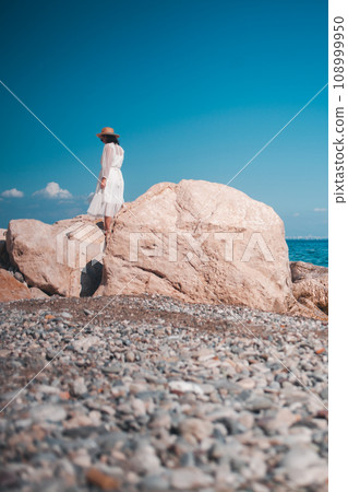 Fashionable woman, Turkish charm, a dress dancing in the sea breeze, epitomizing travel grace. 108999950