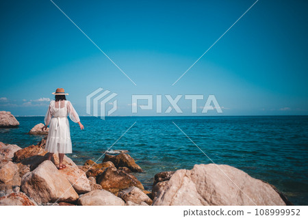 Stylish traveler in Turkey, a dress fluttering seaside 108999952